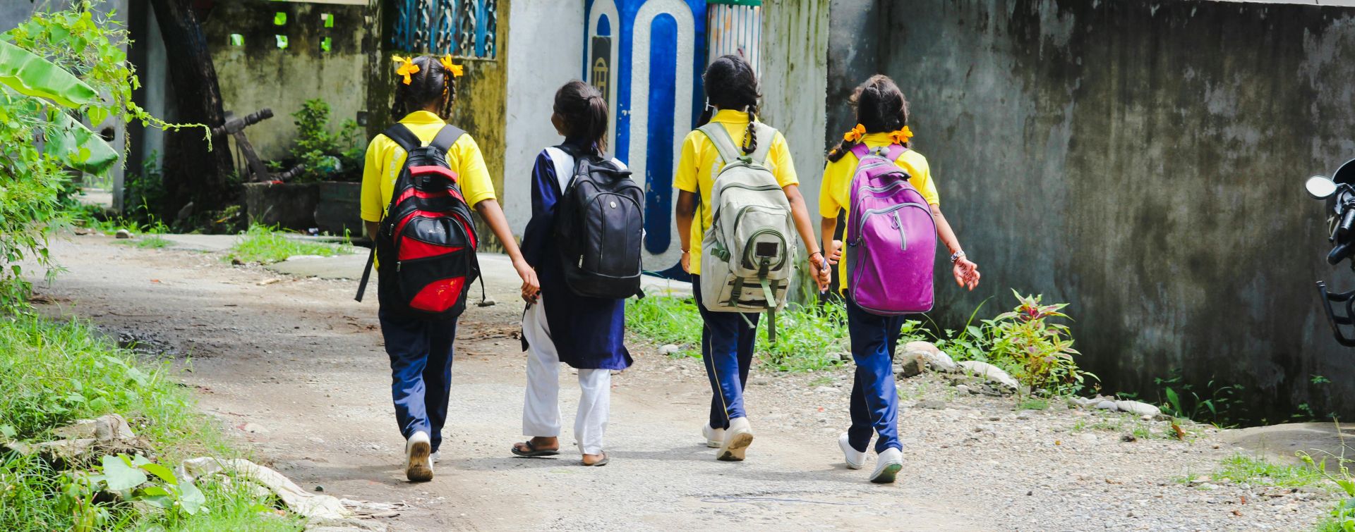 A Group of Friends Walking on the Street while Carrying their Backpacks